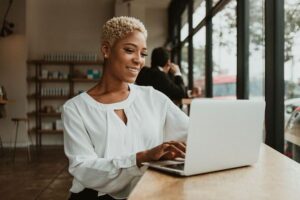 Happy businesswoman in a cafe using her laptop